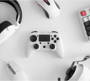 Gaming controller and accessories on white background