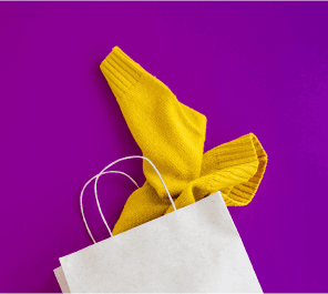 Yellow clothing with white shopping bag on purple background